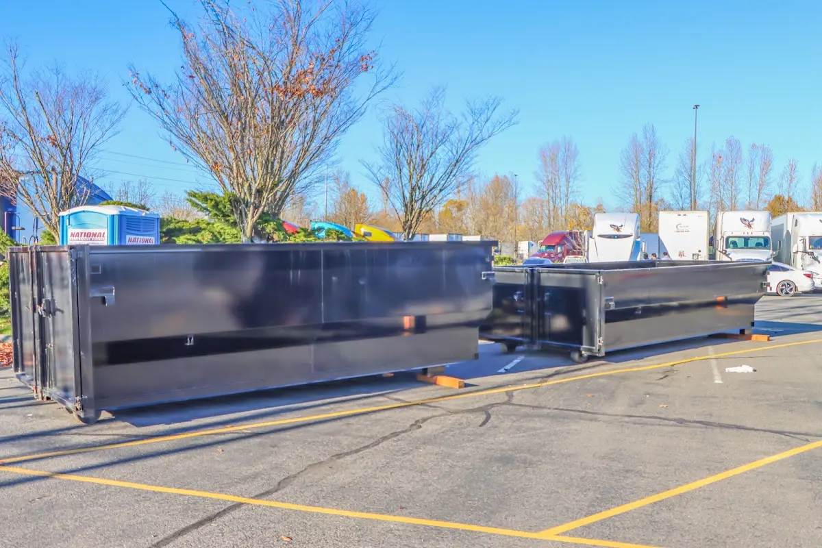 Professional dumpster rental service with roll-off container on residential driveway in Miami